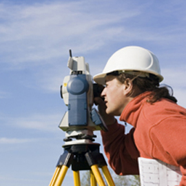 surveyor looking through scope on equipment