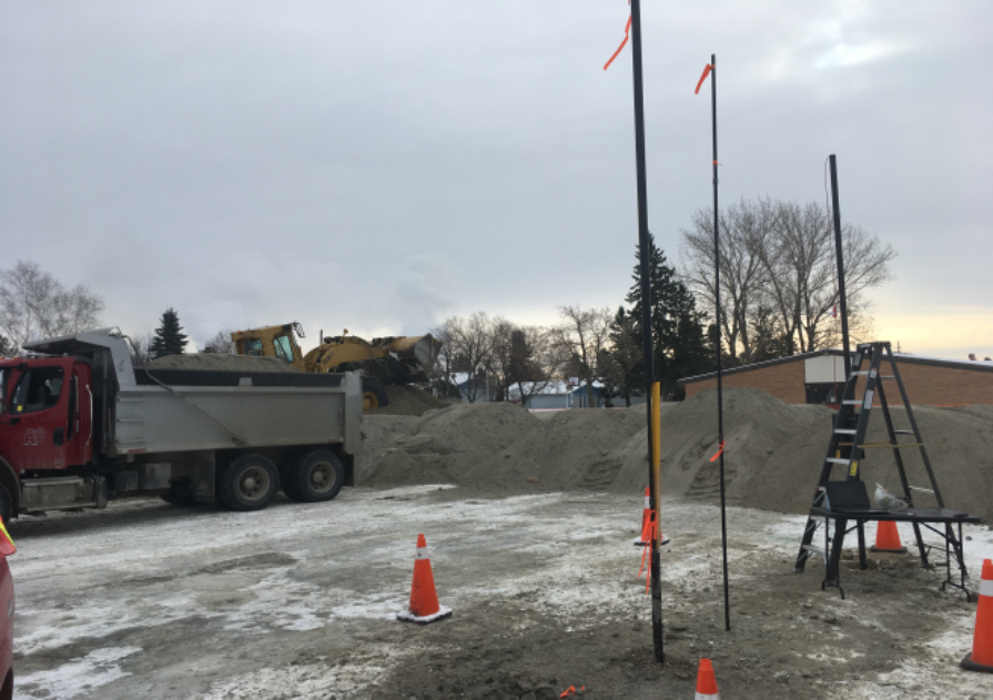 school under construction, piles of dirt